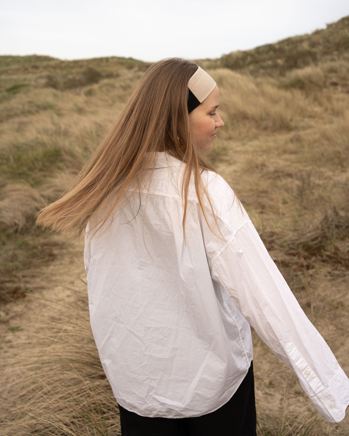 Model wearing headband walking in nature